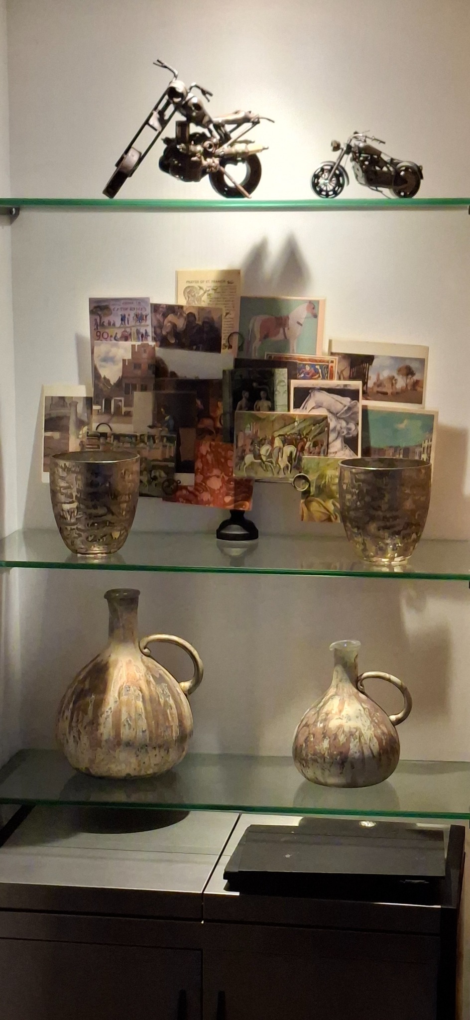 Cabinet of ceramics, postcards and miniature motorcycles
