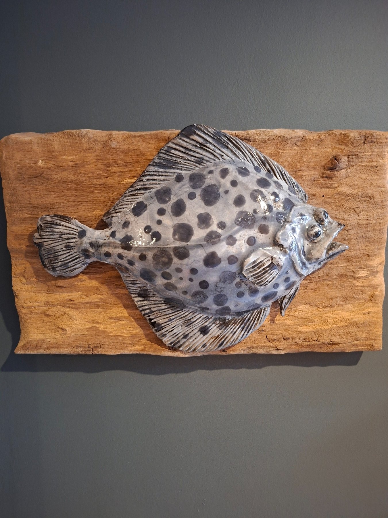 Handmade ceramic fish mounted on reclaimed timber