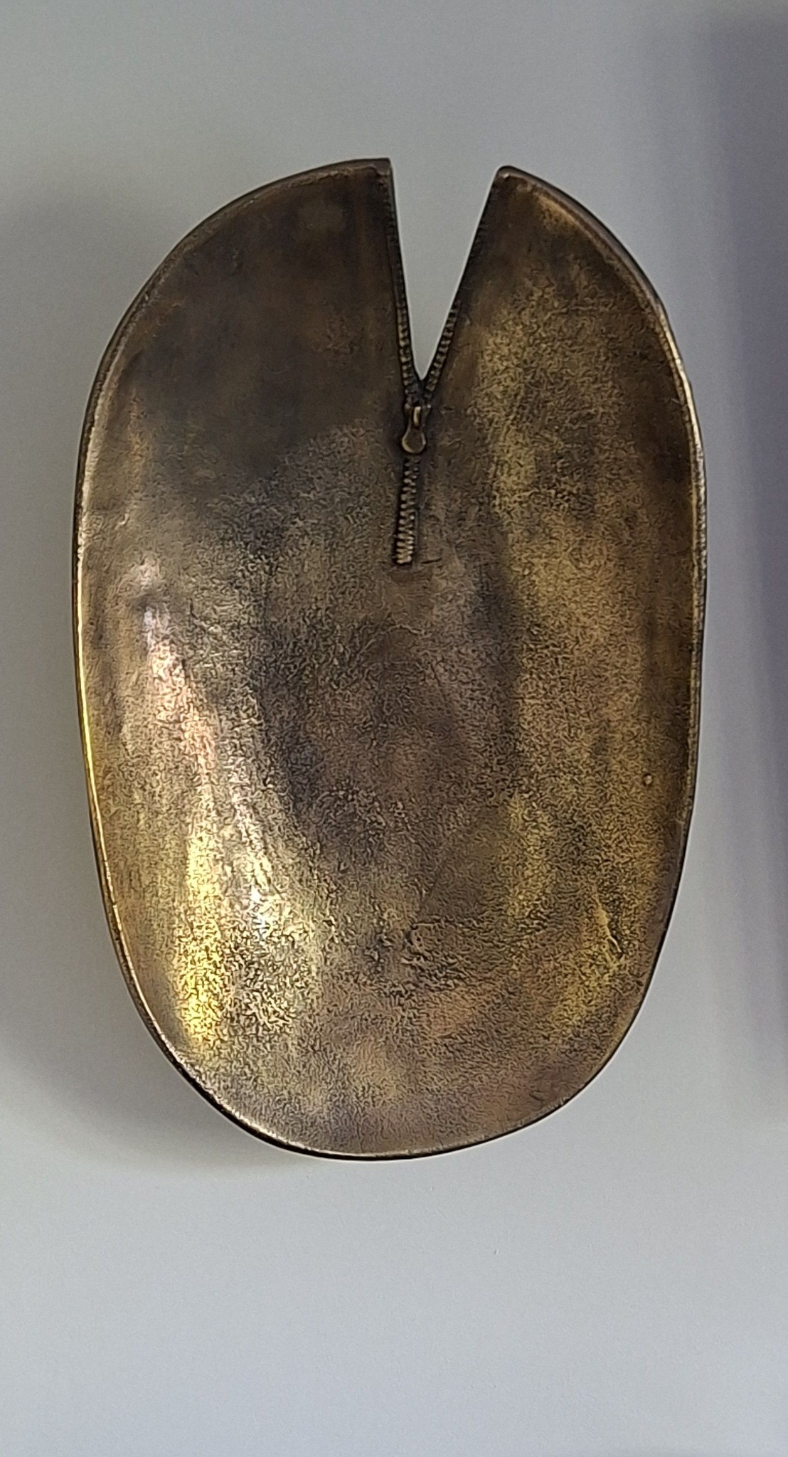 Sculptural brass dish with zip detail