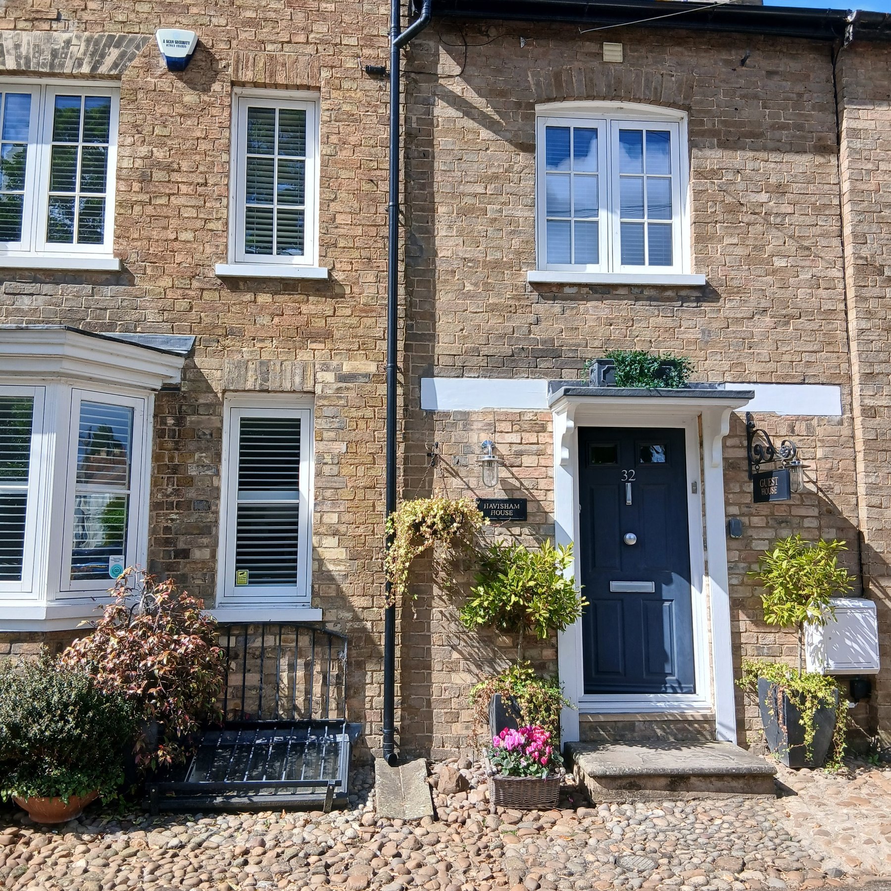The original brick frontage and blue door of Havisham House