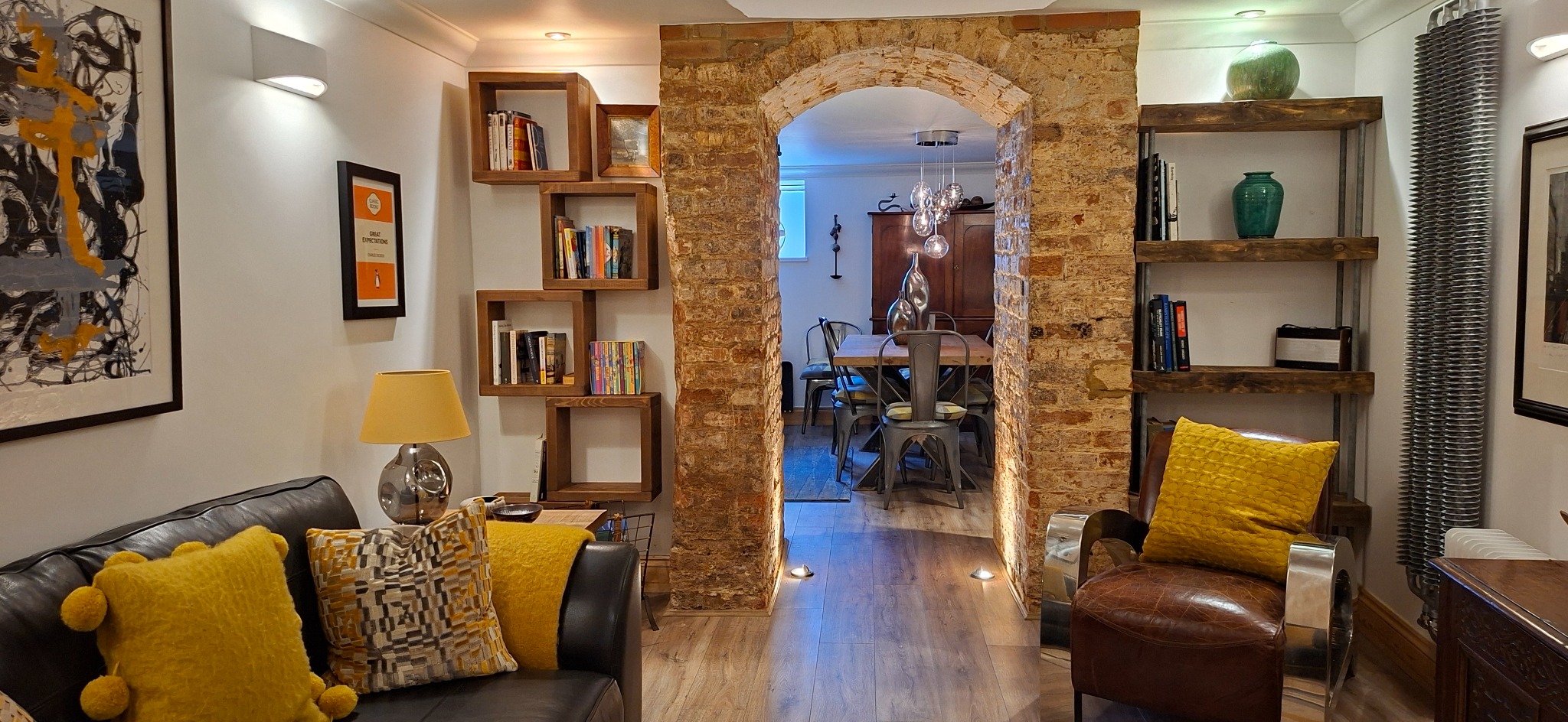 The exposed Victorian brick arch connecting the lower-ground sitting and dining rooms