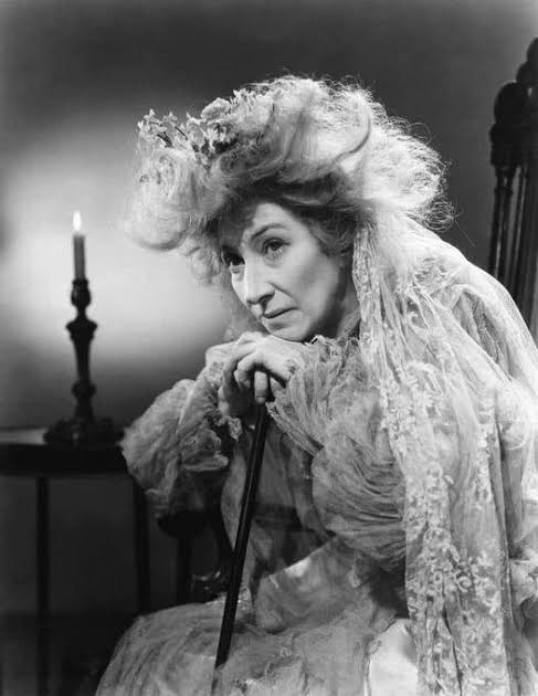 A classic black-and-white portrayal of Miss Havisham from Great Expectations