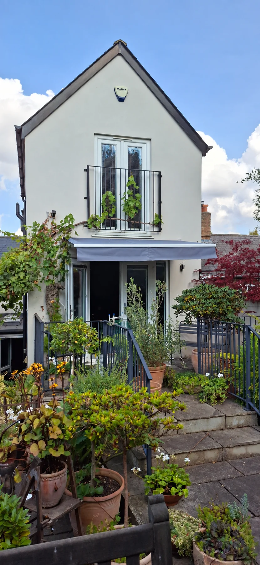 The rear of Havisham House rising above its garden and Juliette balcony