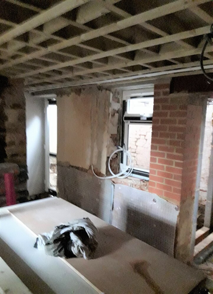 Bathroom being rebuilt, with the house dog inspecting the work